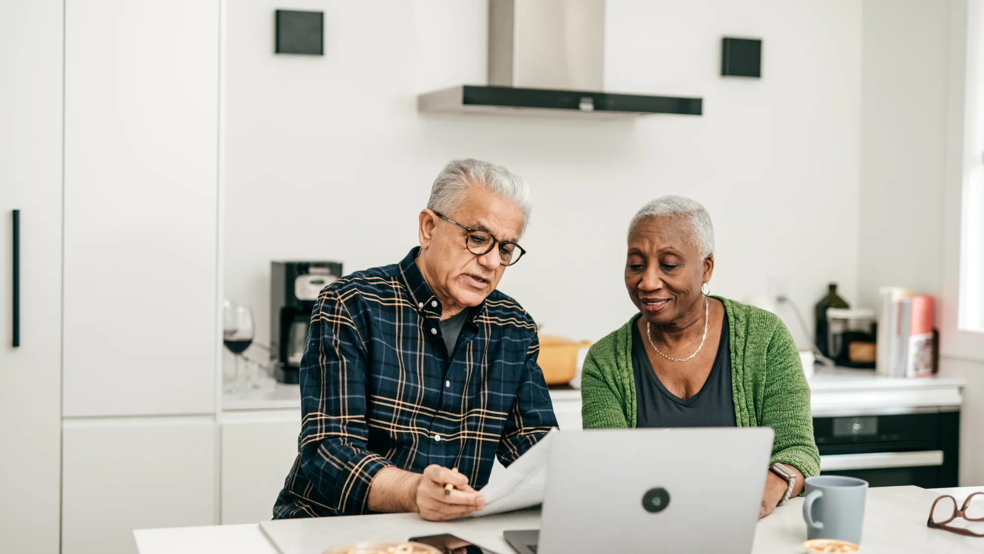 senior people looking paper together