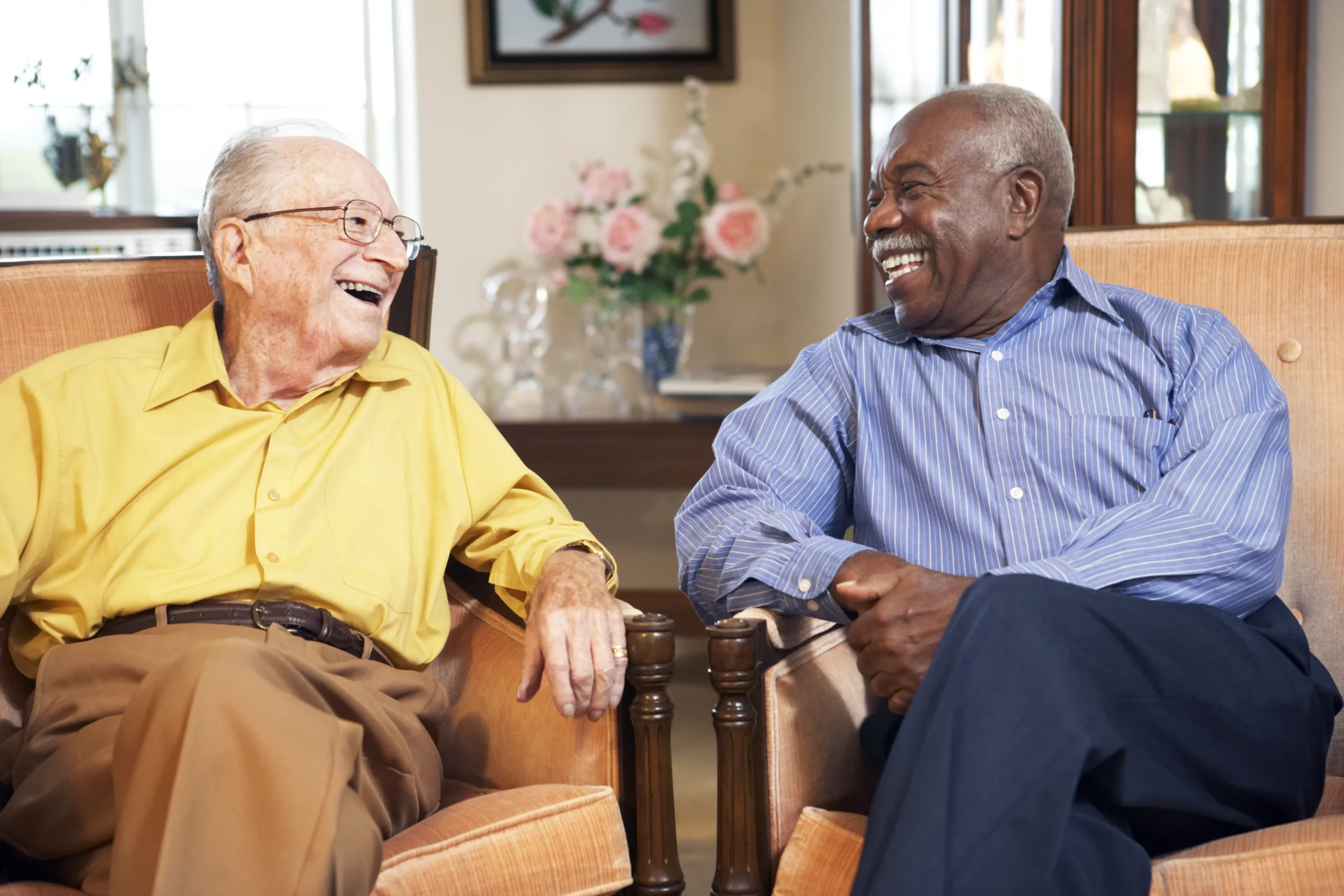 two elderly men smiling together